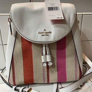New with tags Kate Spade Backpack purse. Never used. White with tan/orange/pink